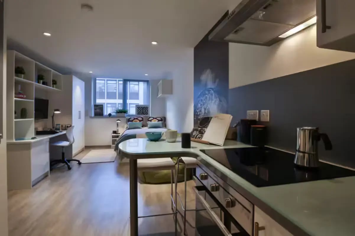 Bed desk and kitchen area studio apartment at College Green in Bristol Student Accommodation