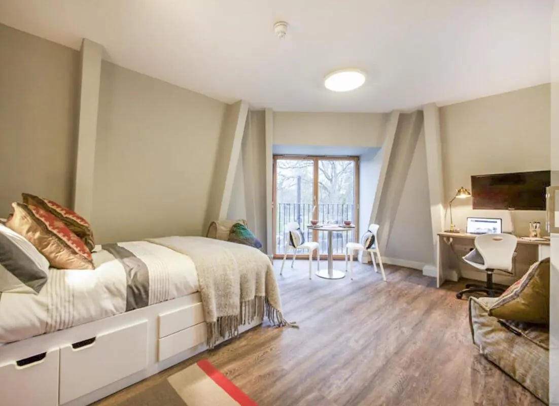 Bed with storage desk table chairs TV bedroom at Halsmere Studios in London Student Accommodation