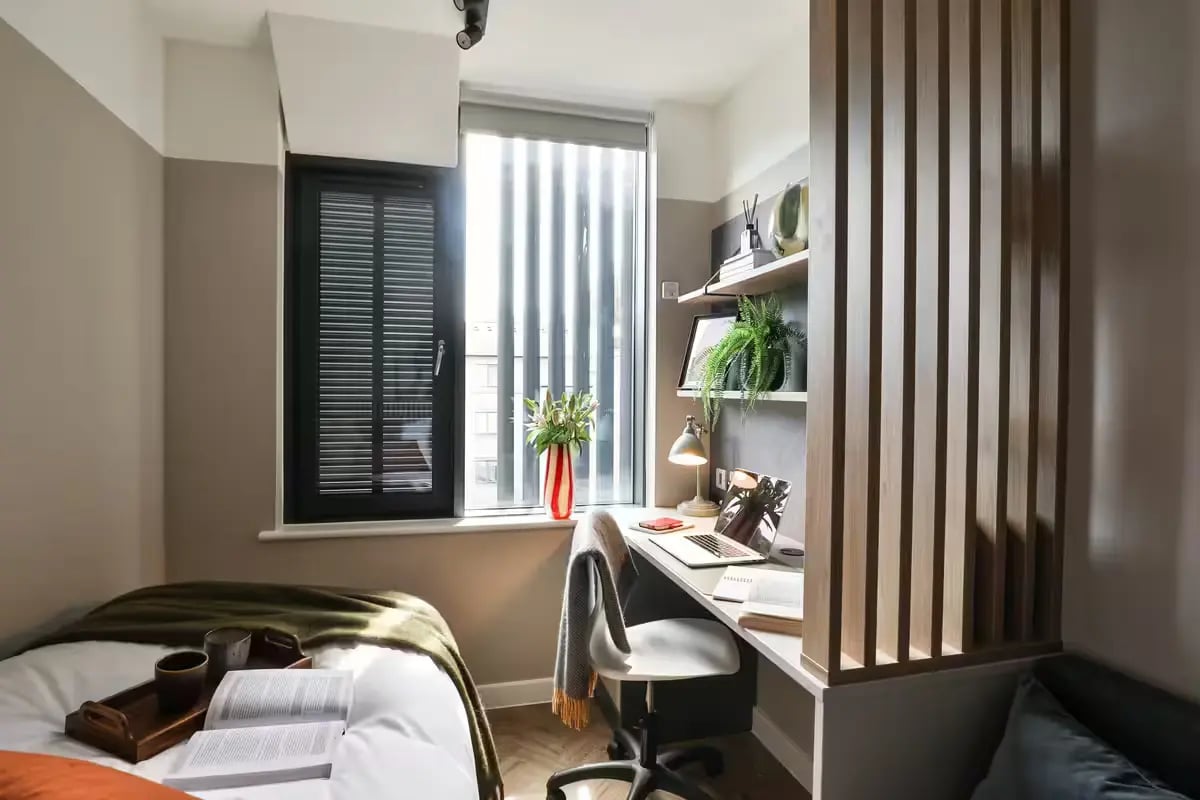 Bed desk window shelves and plants student room at The Exchange in Bath Student Accommodation