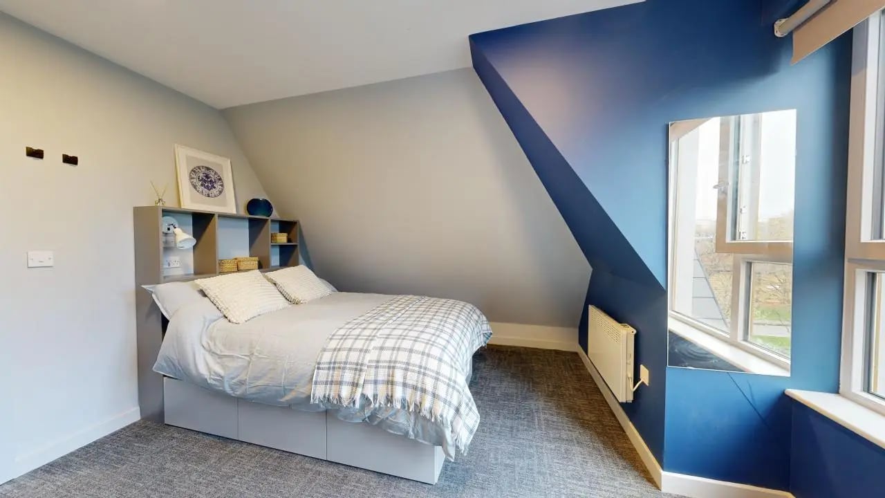 Bed with checkered throw and shelving bedroom at Ash Grove Court - Guildford in Guildford Student Accommodation
