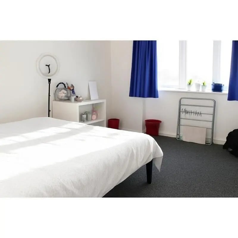 White bed shelf ring light red bins bedroom at Pin Hill in Canterbury Student Accommodation