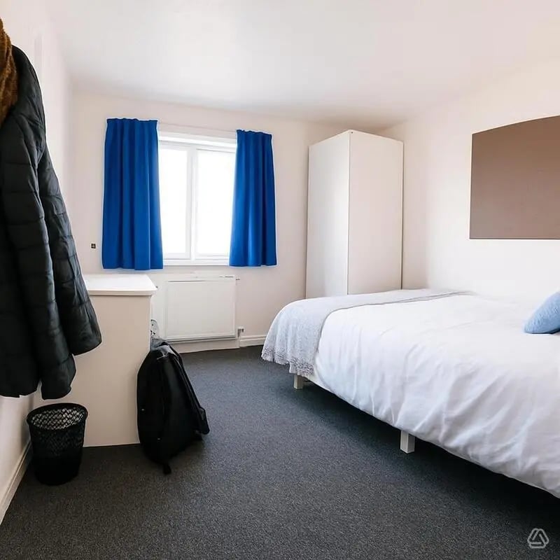 Bed closet desk blue curtains bedroom at Pin Hill in Canterbury Student Accommodation