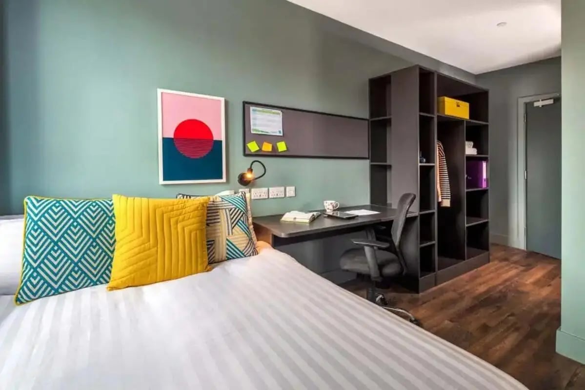 Bed desk chair open shelving unit bedroom at Copley Court in Cork Student Accommodation