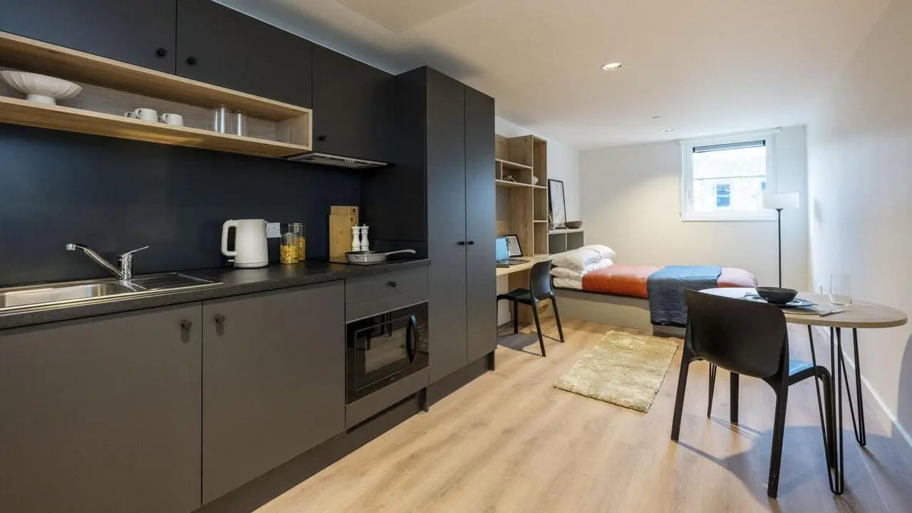 Kitchen bed desk table and chairs studio apartment at Straits Place in Edinburgh Student Accommodation