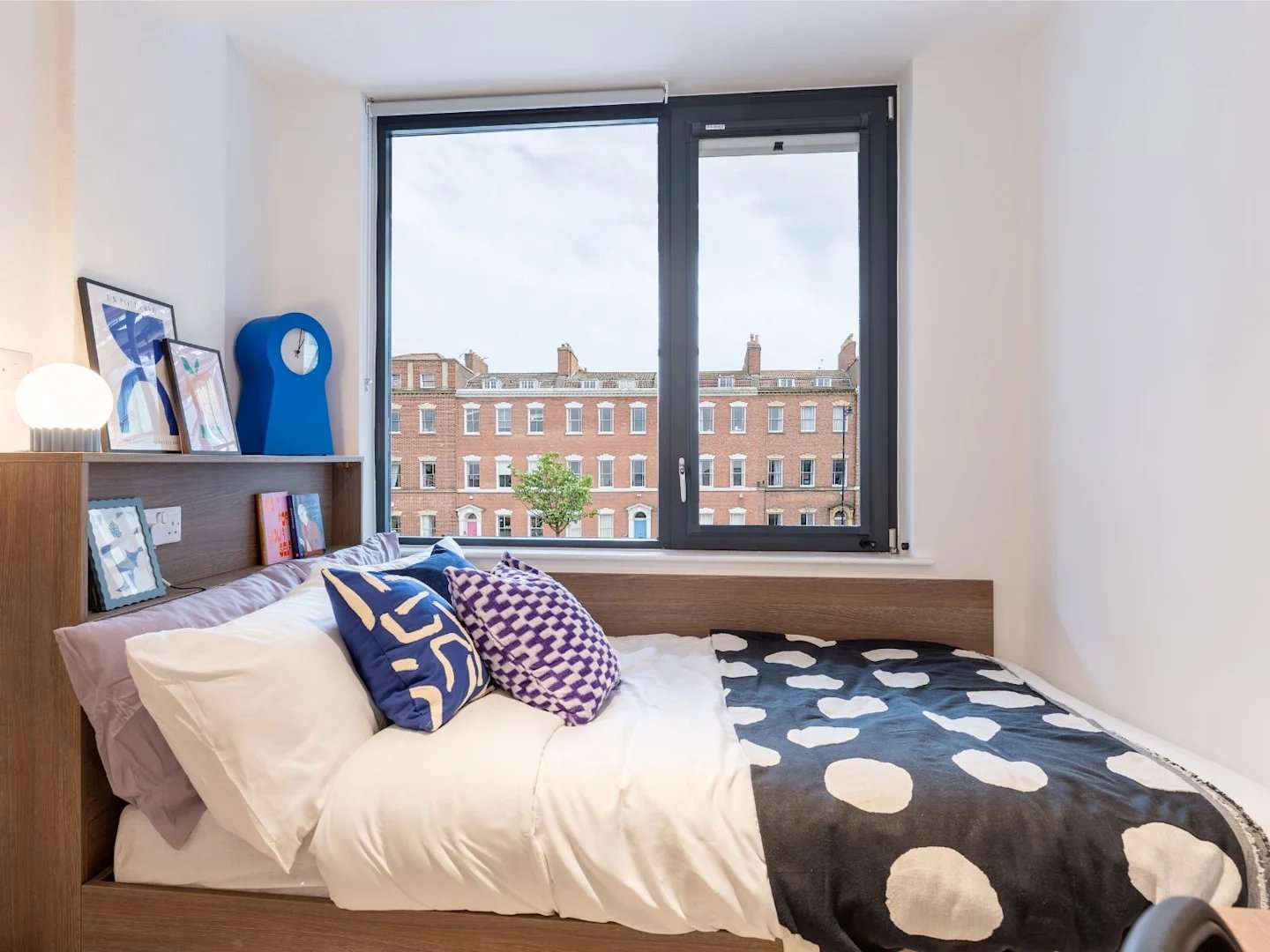 Bed pillows artwork blue clock bedroom at Glassworks in Bristol Student Accommodation