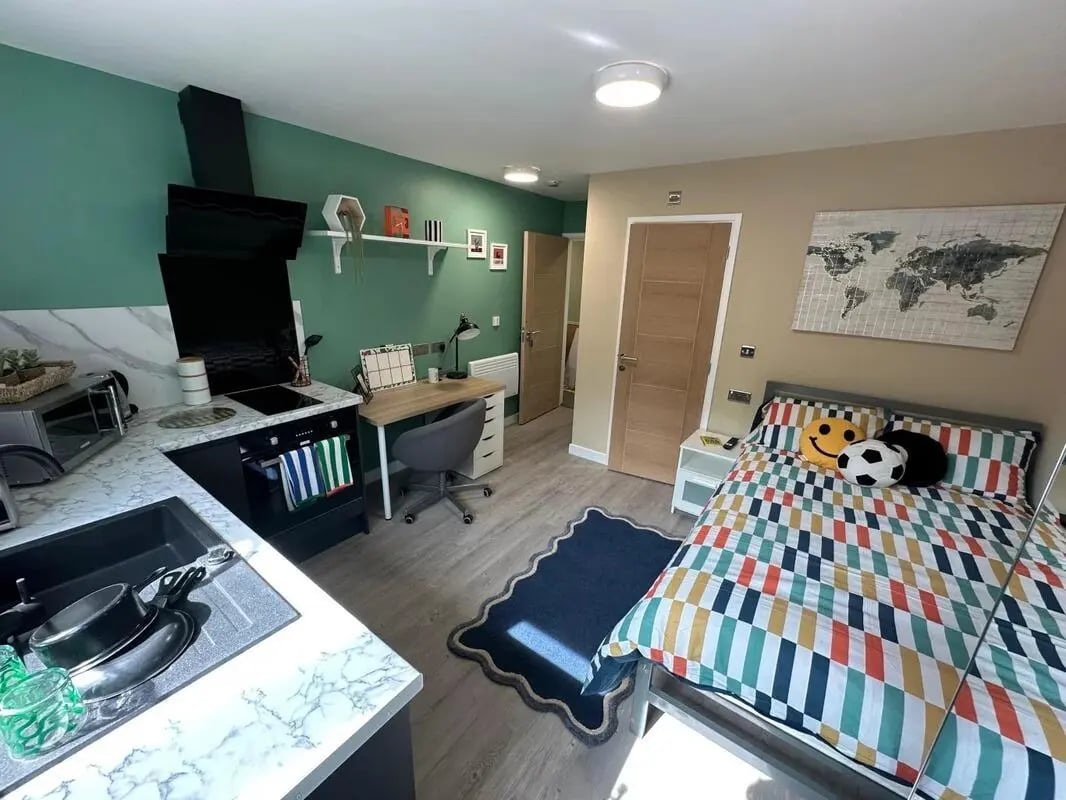 Bed kitchen desk and sink studio apartment at Radmoor House in Loughborough Student Accommodation