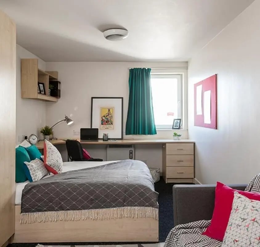 Bed desk laptop pillows and desk lamp bedroom at Albert Court in Liverpool Student Accommodation