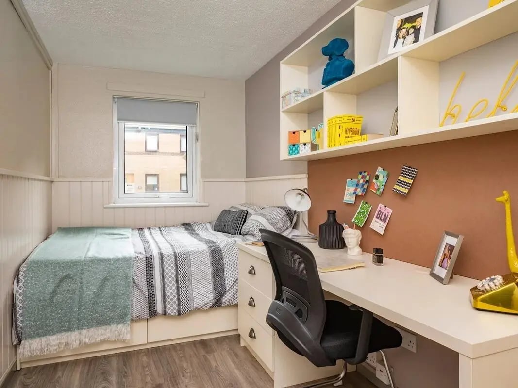 Bed desk shelves with decorations and chair bedroom at Meadow Court in Edinburgh Student Accommodation
