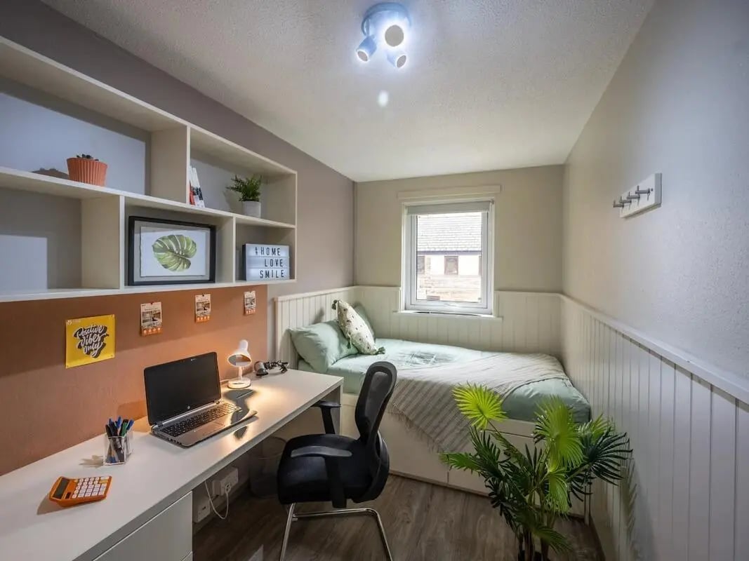 Desk with laptop bed window bedroom at Meadow Court in Edinburgh Student Accommodation