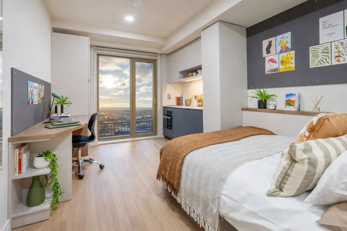 Desk bed and kitchenette with city view studio at Broadway Studios in Glasgow Student Accommodation
