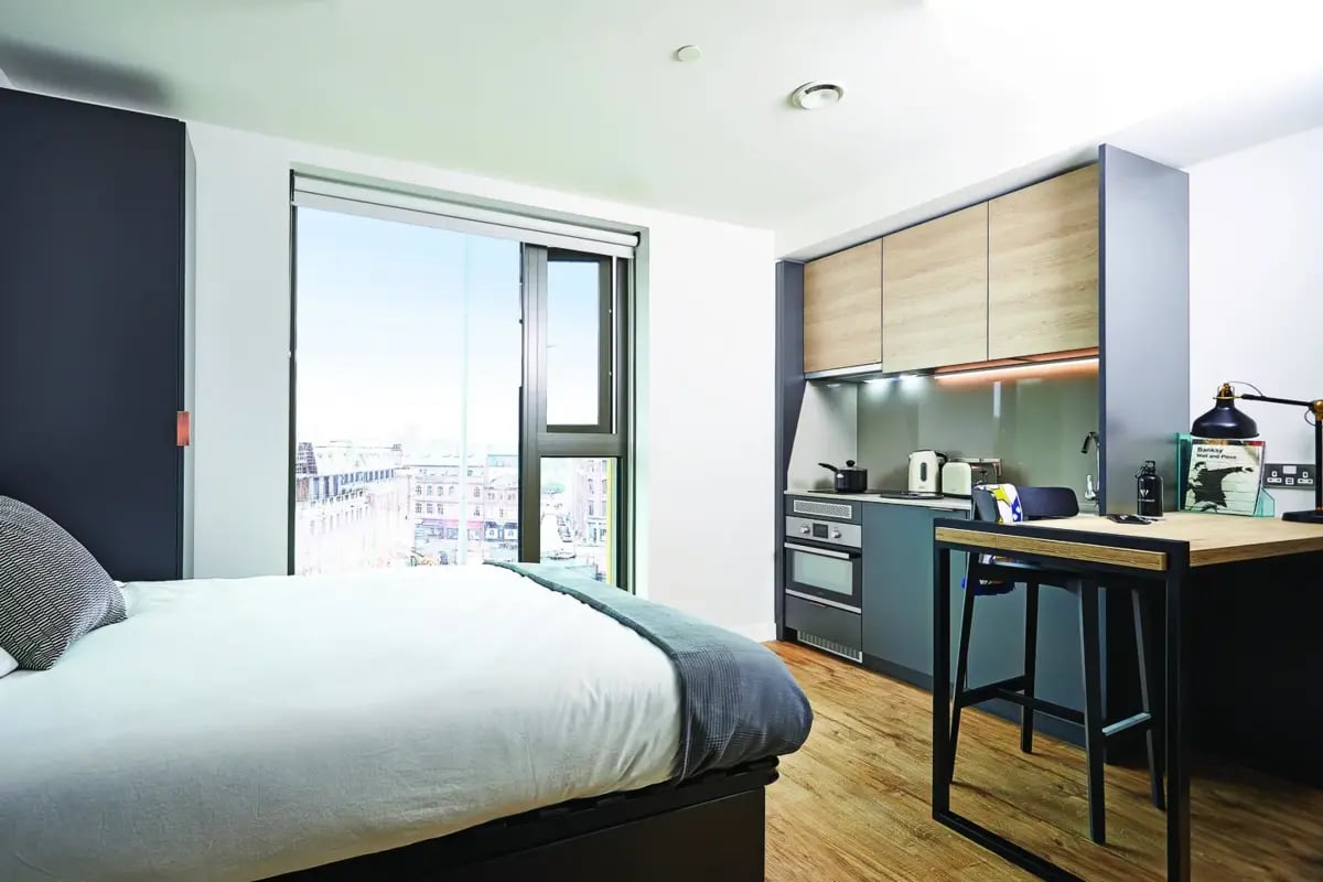Bed wardrobe modern kitchen and desk area studio at Vita Student St.Albans in Leeds Student Accommodation