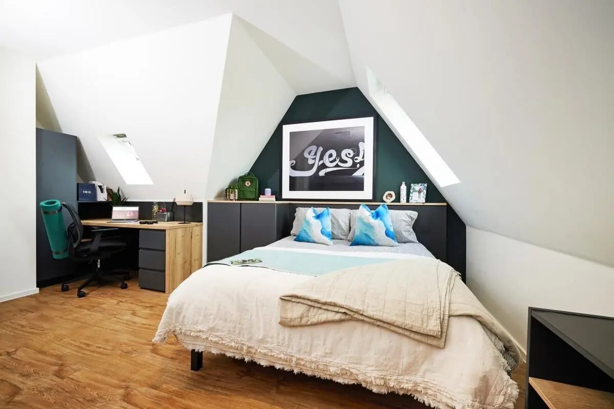 Desk bed with artwork and pillows bedroom at Vita Student Park Place in Cardiff Student Accommodation