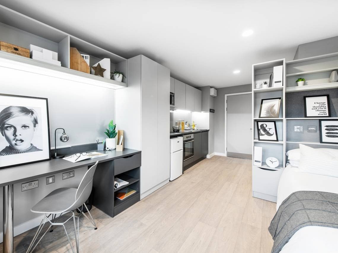 Desk with Twiggy portrait and kitchen area studio at Clifford House in Exeter Student Accommodation