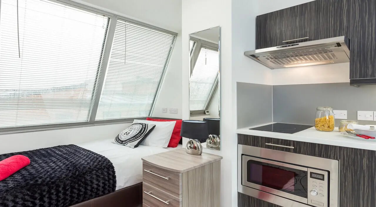 Bed, microwave, stove, window Student studio at Queens Gate in Southampton Student Accommodation