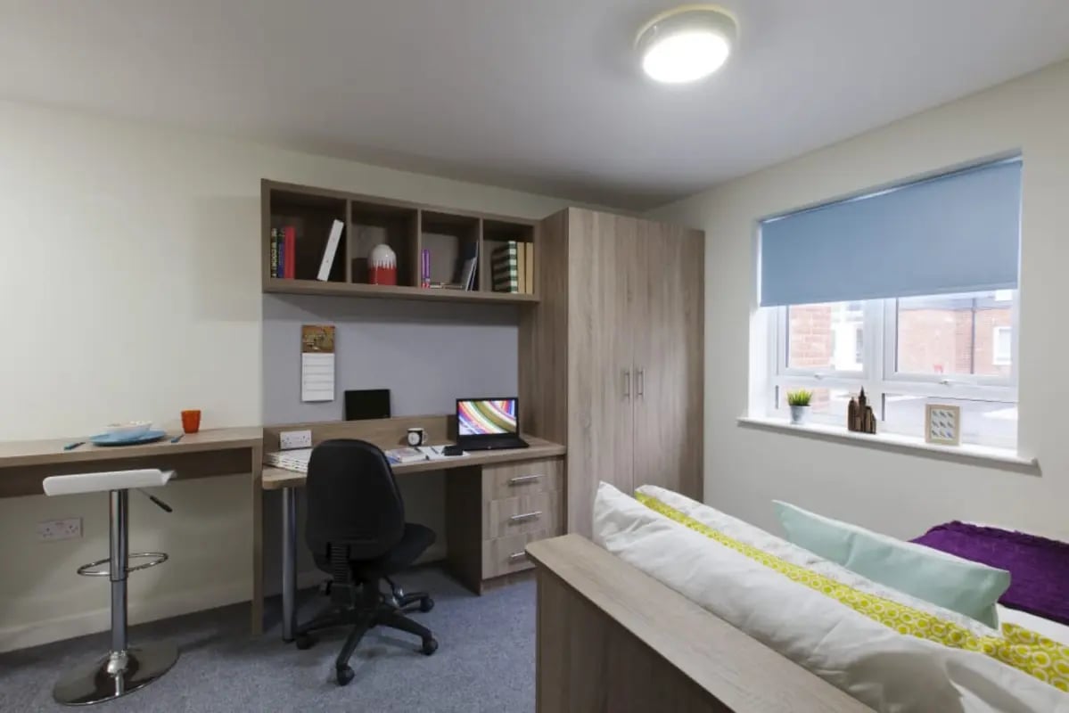 Desk chair laptop shelves bed and window bedroom at Selly Oak Court in Birmingham Student Accommodation