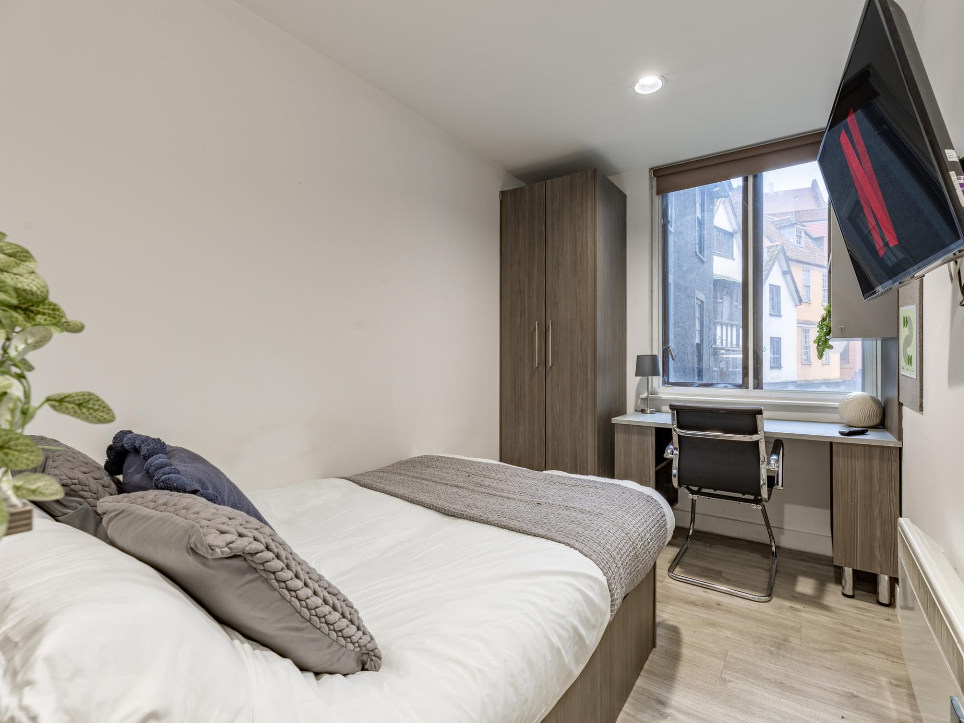 Bed wardrobe desk chair and TV Bedroom at Centre Gate in Bristol Student Accommodation