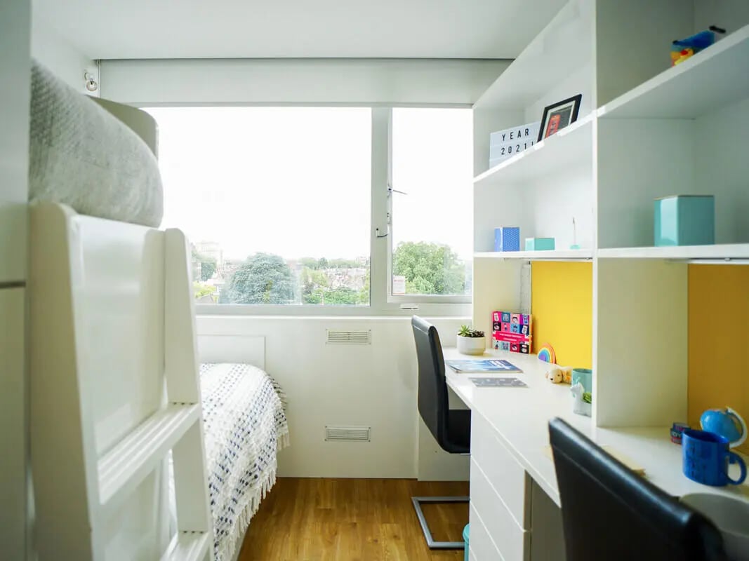 Bunk bed desk shelves with decor and window Bedroom study area at Chelsea Lightfoot Hall in London Student Accommodation