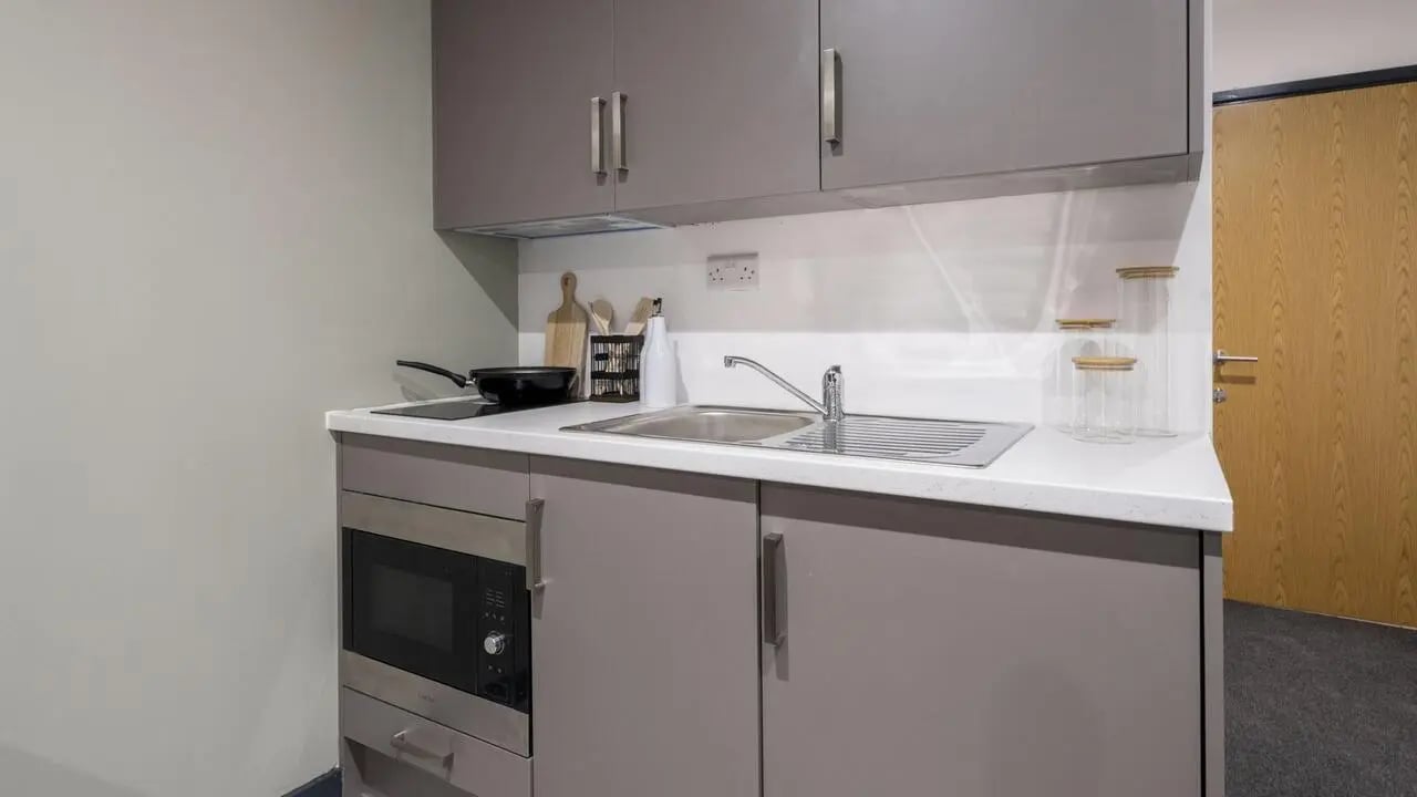 Microwave sink and cupboards kitchen at Icon House in Stoke-On-Trent Student Accommodation