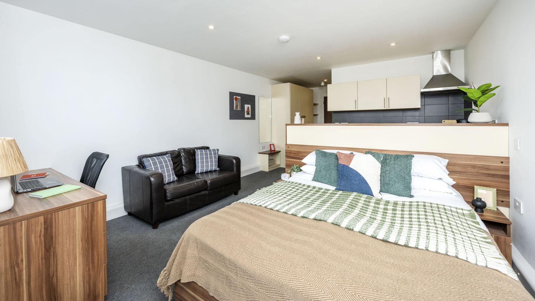 Bed sofa desk and kitchen area studio apartment at Windsor Court in Liverpool Student Accommodation