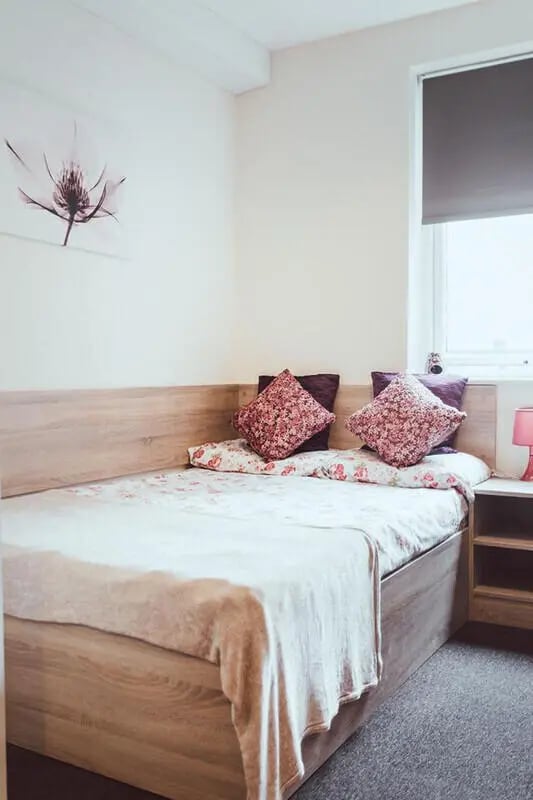 Bed with patterned pillows and blanket Bedroom at Jubilee Court in Preston Student Accommodation