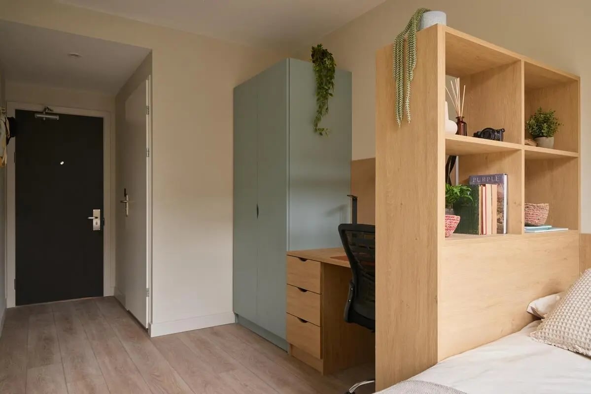Wardrobe desk chair shelves bed study area bedroom at Ark Canning Town in London Student Accommodation