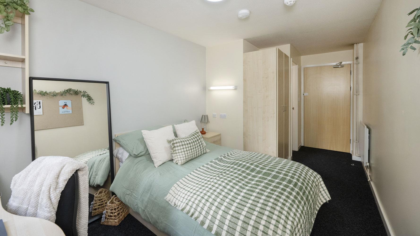 Bed wardrobe and mirror student bedroom at The Pinnacles in Sheffield Student Accommodation