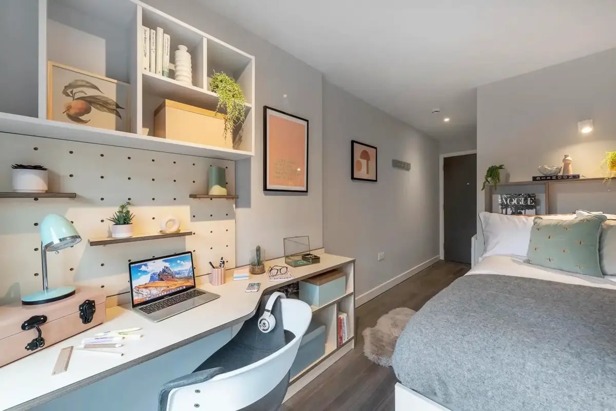 Desk, bed, shelves, framed art, bedroom at The Aspen in Leicester Student Accommodation