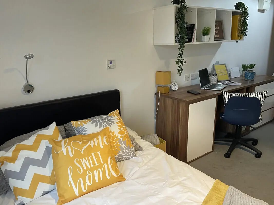 Bed desk with laptop and chair bedroom at Austin Hall in Leeds Student Accommodation