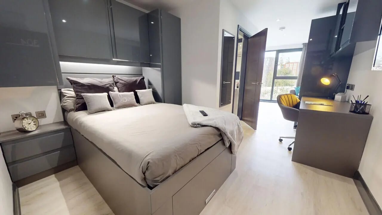 Bed with pillows desk with lamp and chair Bedroom at The Residence in Coventry Student Accommodation