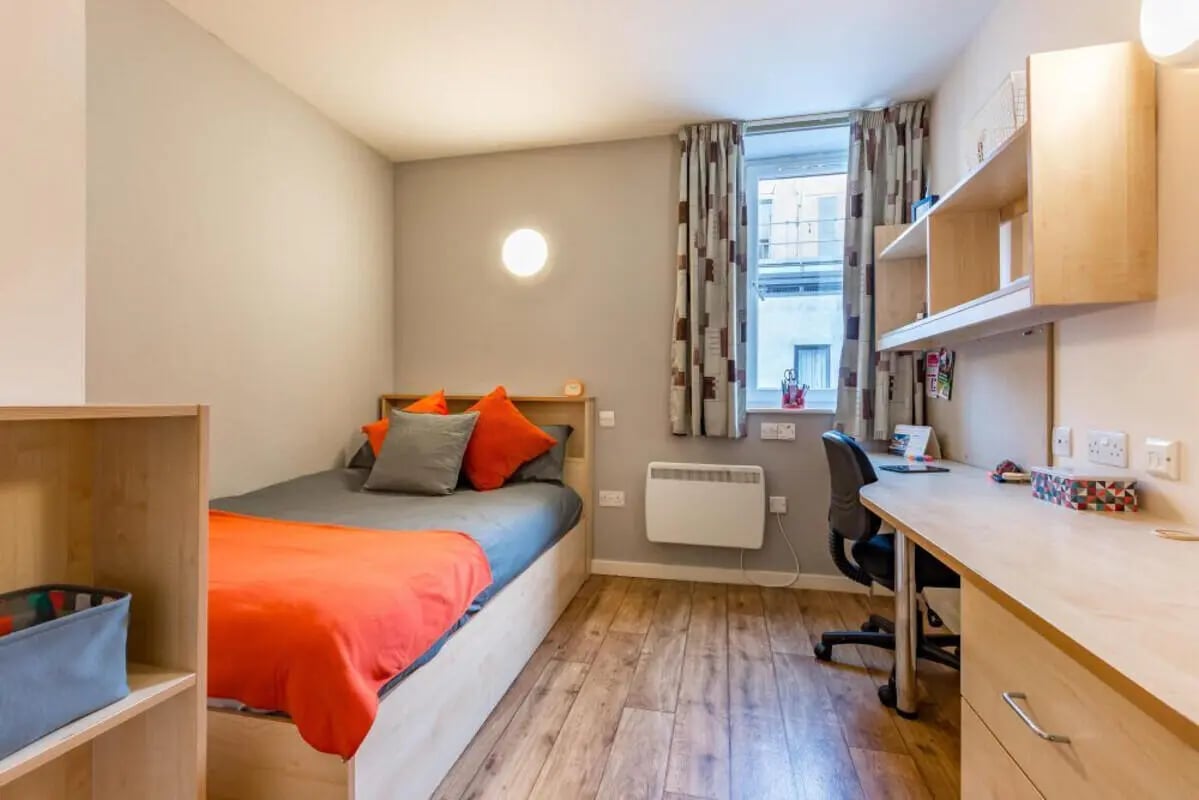 Bed desk chair shelves curtains radiator bedroom at Chambers 51 in Wolverhampton Student Accommodation
