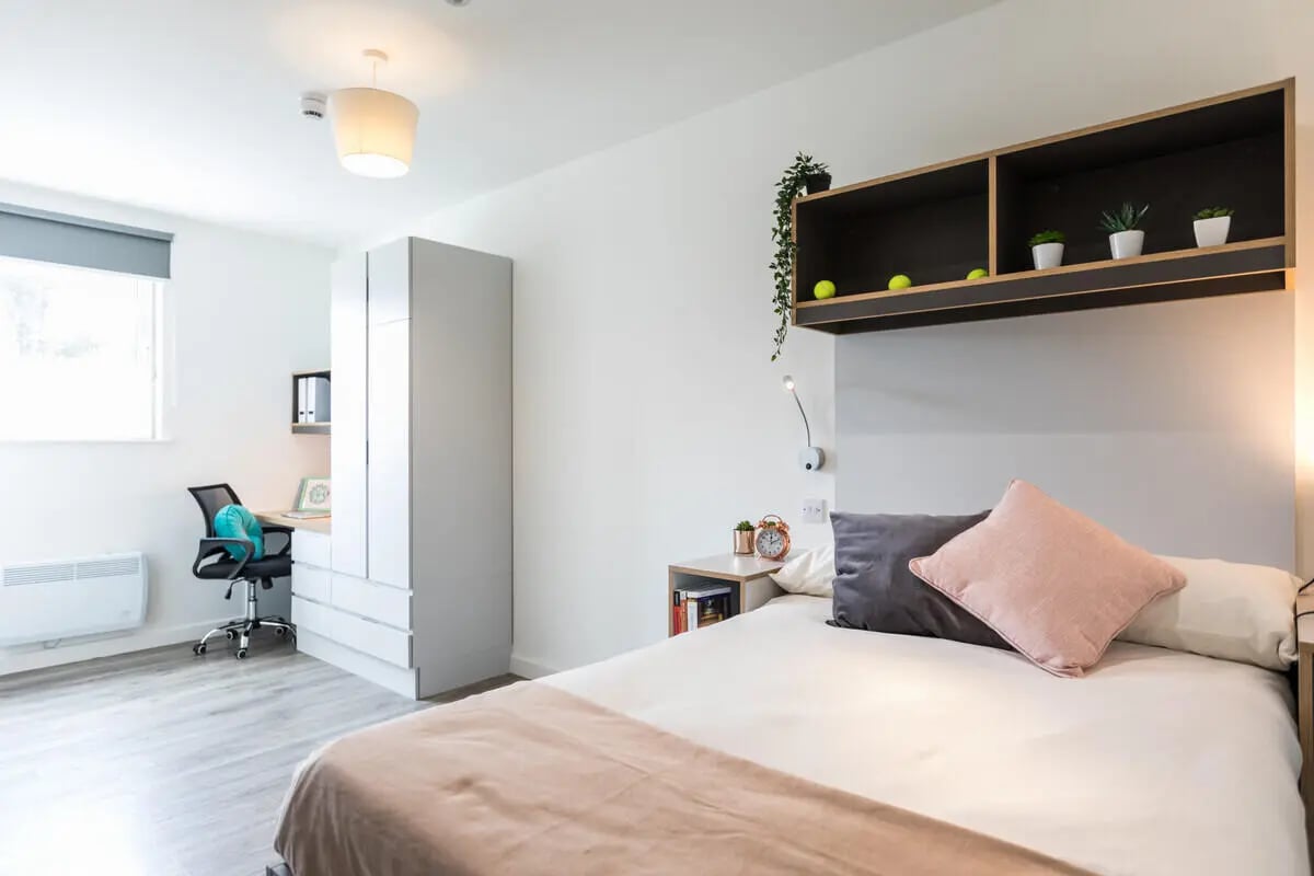 Bed desk wardrobe and shelf bedroom at The Cam Foundry in Cambridge Student Accommodation
