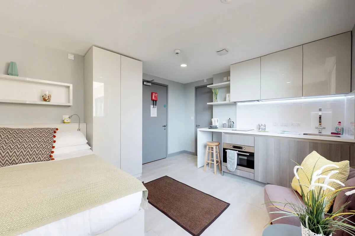 Bed wardrobe kitchen living area studio at The Walls in Southampton Student Accommodation