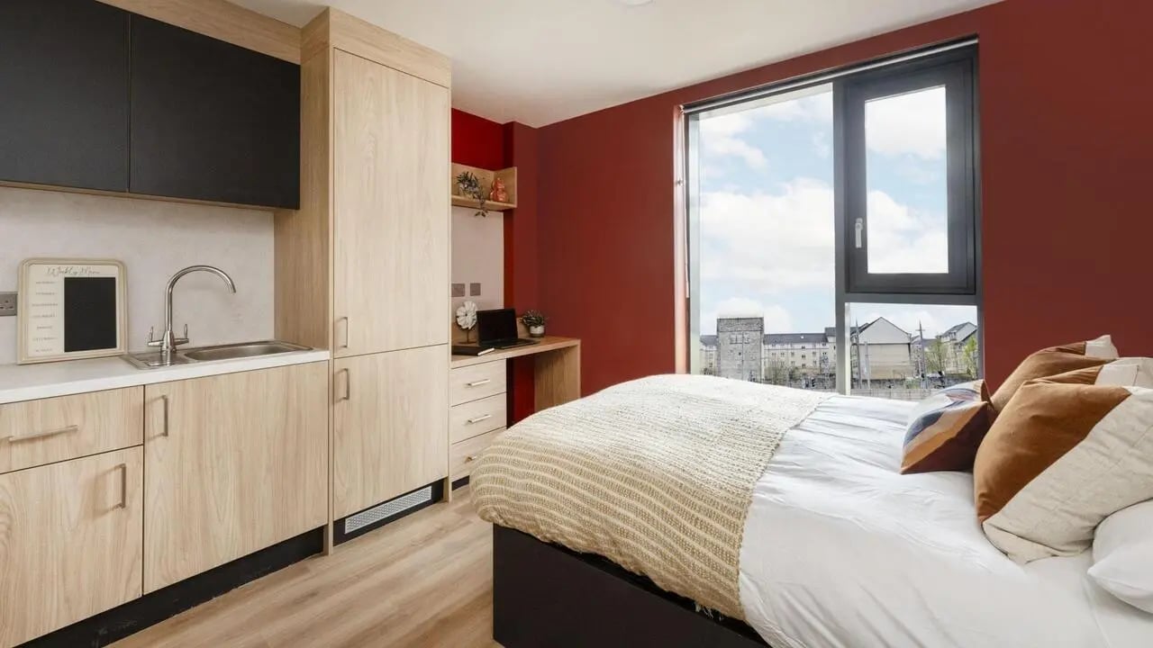 Bed with sink and desk student accommodation bedroom at Haymarket Yards in Edinburgh Student Accommodation