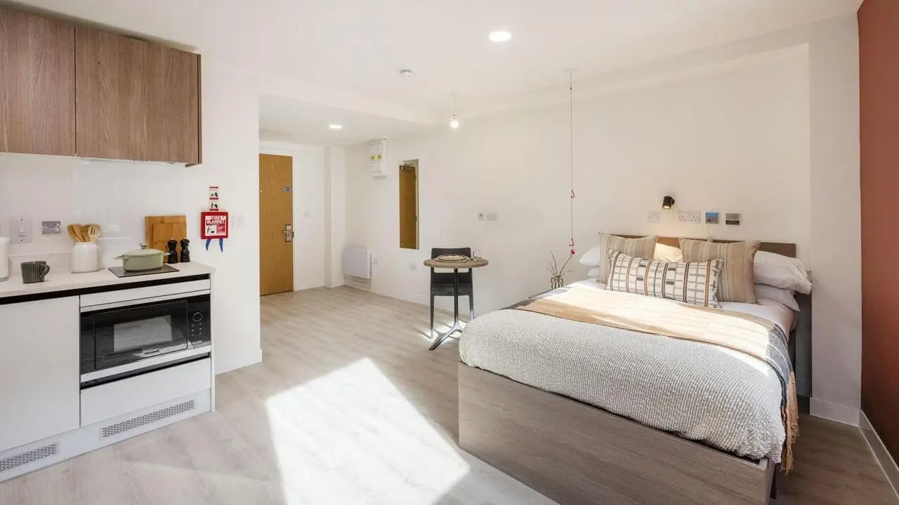 Bed kitchen table and door student studio at Raffles Hall in York Student Accommodation
