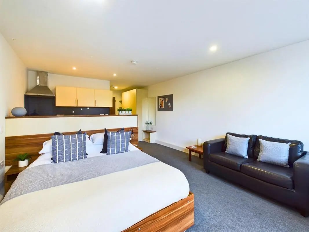 Bed sofa kitchen counter with cabinets studio apartment at Windsor Court in Liverpool Student Accommodation