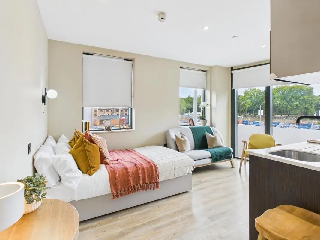Bed sofa kitchen counter and sink living area at Tribu Kingston in Kingston Upon Thames Student Accommodation