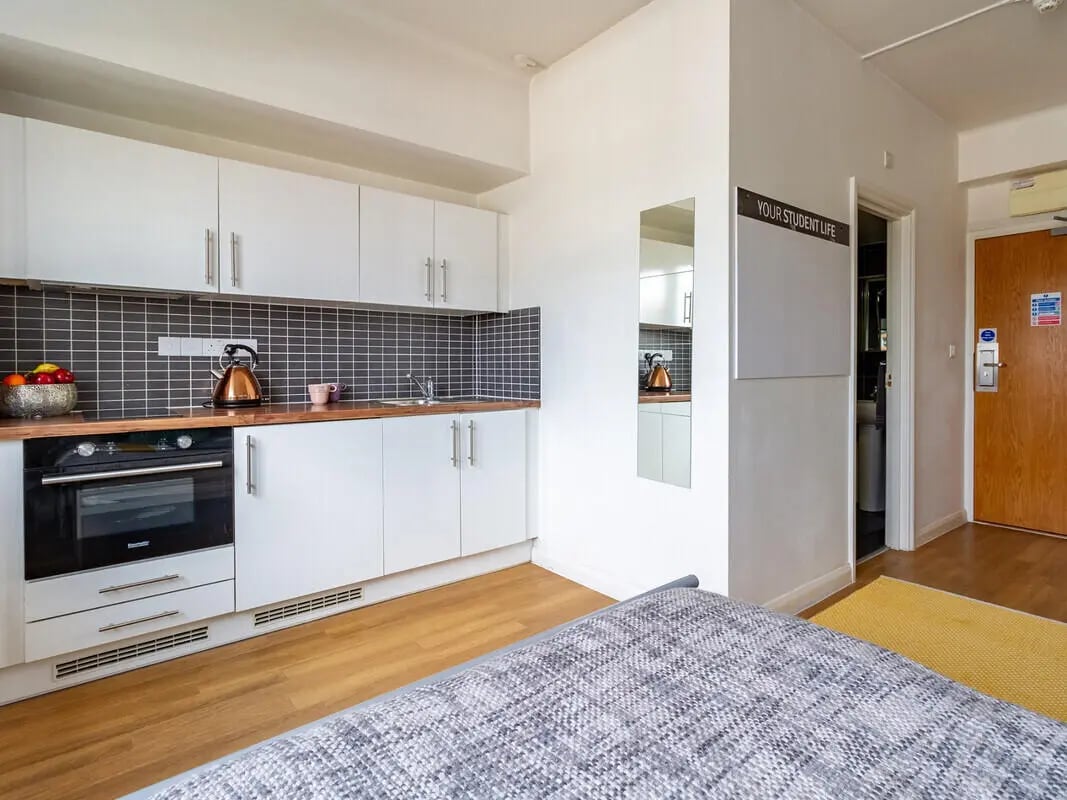 White cabinets oven sink kettle fruit bowl kitchen at Portobello Garrow House in London Student Accommodation