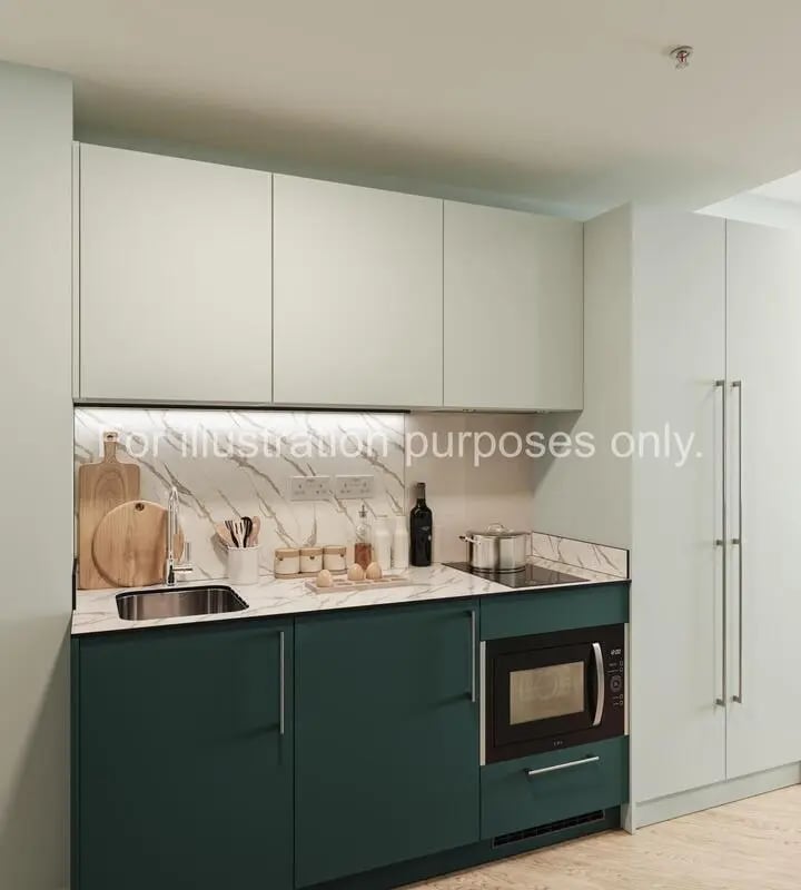 Modern green and cream kitchen with microwave and hob kitchen at Willen House in London Student Accommodation