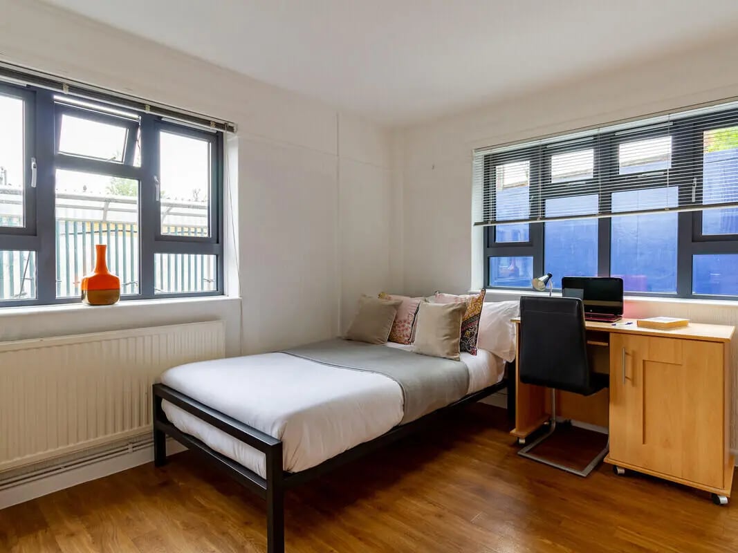 Bed desk laptop and chair student bedroom at Surrey Quays Landale House in London Student Accommodation