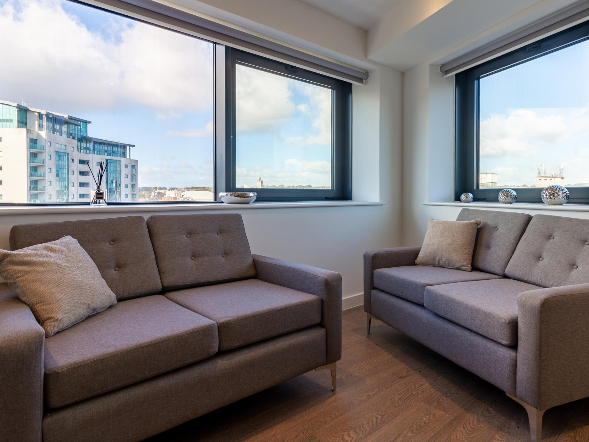 Two grey sofas with cushions living room at Saltwater Place in Plymouth Student Accommodation