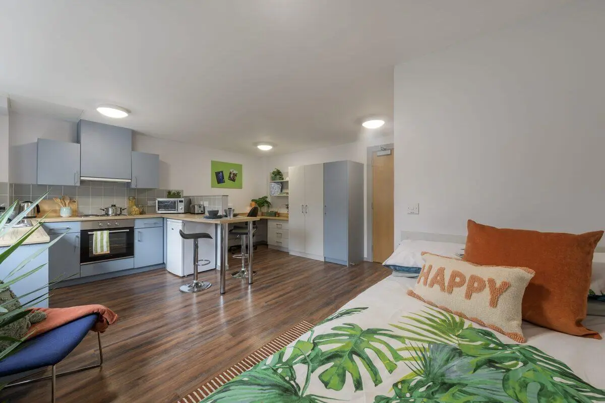 Kitchen area with bed and pillows Studio apartment at Newton Court in Newcastle Upon Tyne Student Accommodation
