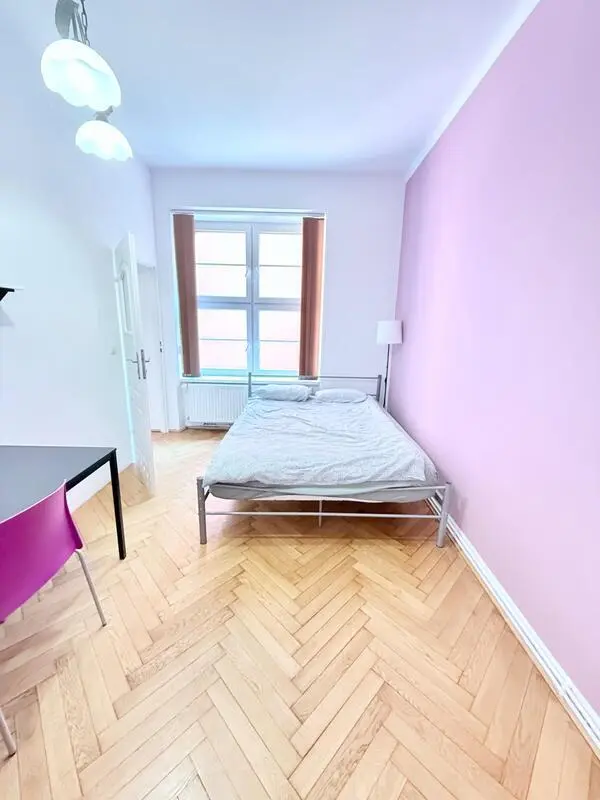 Sunny bedroom with a big bed in the center